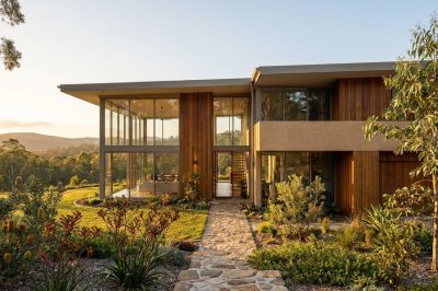 Modern Queensland custom-built home exterior at golden hour with timber and glass facade, Gold Coast Brisbane custom vs volume builder